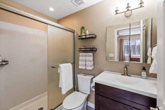 full bath with vanity, toilet, visible vents, and a shower stall