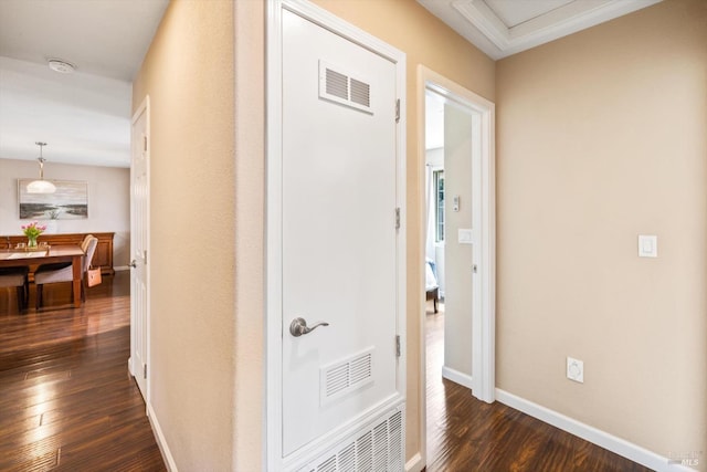 corridor featuring dark wood finished floors, visible vents, and baseboards