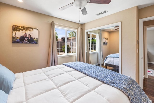 bedroom with wood finished floors, a closet, visible vents, ceiling fan, and recessed lighting