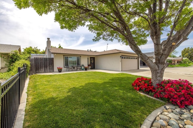 view of front facade with concrete driveway, stucco siding, an attached garage, and fence
