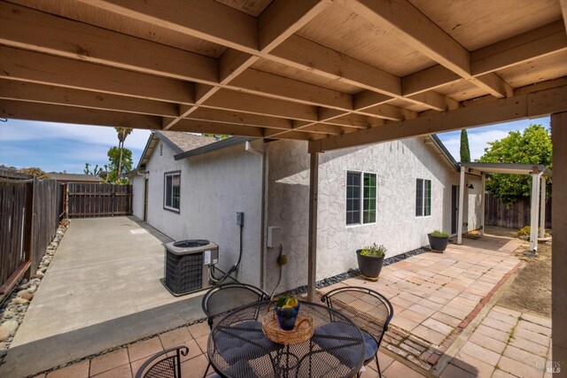 view of patio / terrace with central air condition unit and a fenced backyard