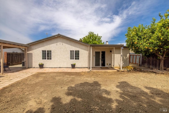 back of property featuring a patio area, stucco siding, and fence