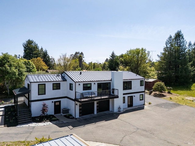 3314 Gravenstein Hwy S, Sebastopol, CA 95472 - modern farmhouse featuring a balcony, an attached garage, a standing seam roof, stucco siding, and metal roof