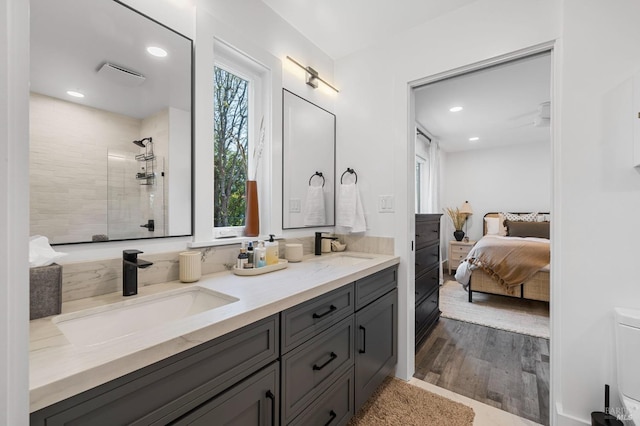 3314 Gravenstein Hwy S, Sebastopol, CA 95472 - ensuite bathroom featuring tiled shower, double vanity, wood finished floors, recessed lighting, and toilet