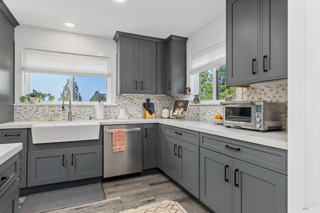 3314 Gravenstein Hwy S, Sebastopol, CA 95472 - kitchen with stainless steel dishwasher, a sink, gray cabinets, wood finished floors, and recessed lighting