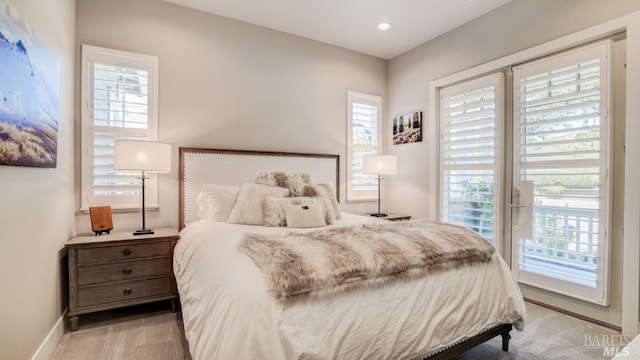 bedroom featuring baseboards, multiple windows, and carpet flooring