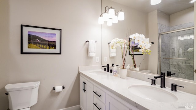 full bathroom featuring a sink, toilet, and a shower stall