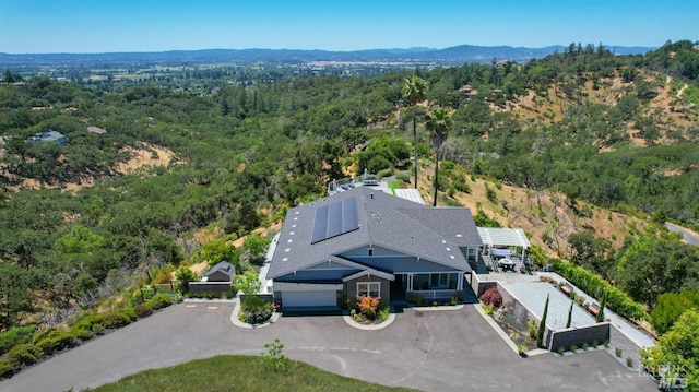 birds eye view of property featuring a view of trees