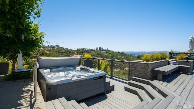 wooden deck with a hot tub