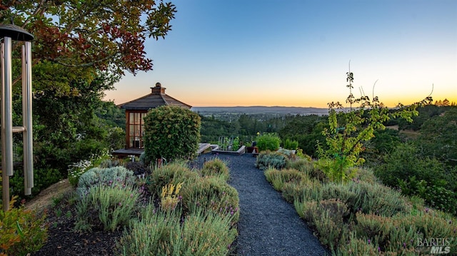 yard at dusk with a gazebo