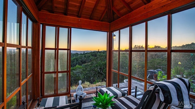 sunroom with vaulted ceiling and wood ceiling