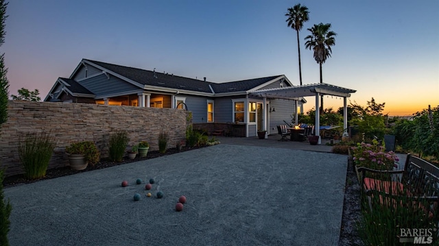 view of front of house featuring a pergola, fence, and a patio