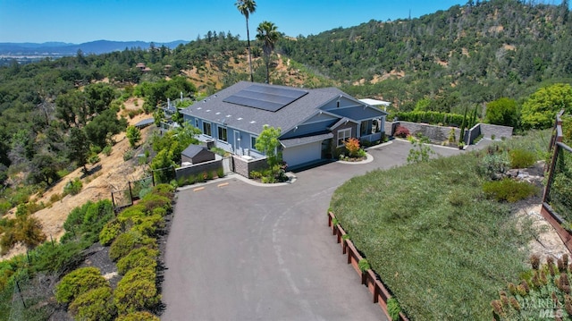 aerial view with a mountain view and a wooded view