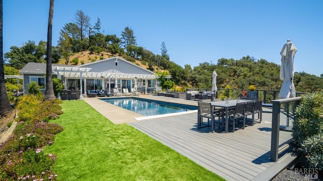 outdoor pool with an outdoor living space, outdoor dining area, a wooden deck, a yard, and a pergola