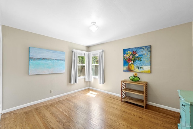 empty room featuring baseboards and wood finished floors