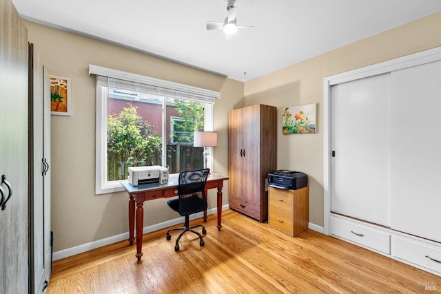 office area featuring light wood-style floors, baseboards, and a ceiling fan