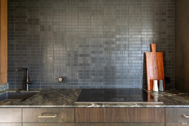 1499 Rockville Rd, Fairfield, CA 94534 - kitchen view of a sink, black electric stovetop, tasteful backsplash, and dark stone countertops