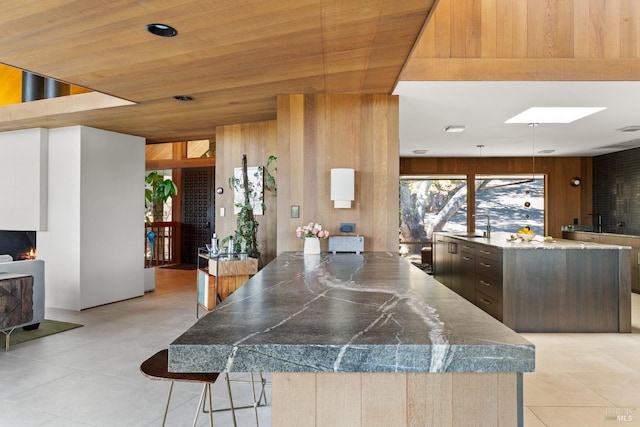 1499 Rockville Rd, Fairfield, CA 94534 - kitchen with a kitchen breakfast bar, light tile patterned floors, a skylight, a sink, and a large fireplace