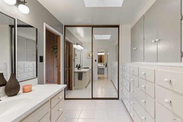 1499 Rockville Rd, Fairfield, CA 94534 - bathroom featuring two vanities, tile patterned floors, a skylight, and ensuite bathroom