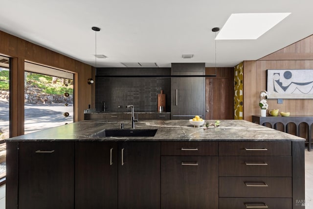 1499 Rockville Rd, Fairfield, CA 94534 - kitchen featuring a sink, wood walls, modern cabinets, dark brown cabinets, and dark stone countertops
