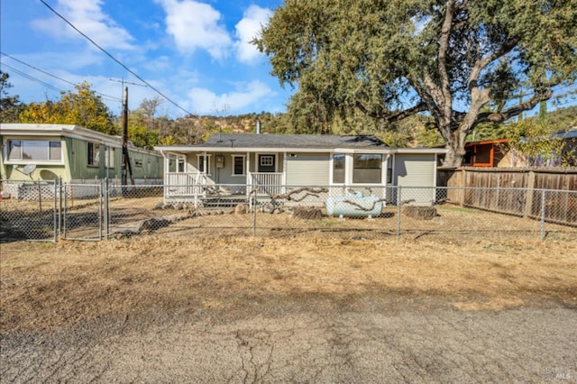 view of front of home featuring a gate, a fenced front yard, and covered porch
