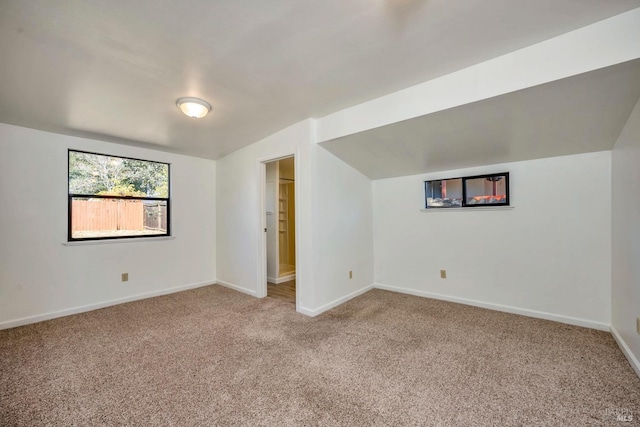 interior space featuring baseboards and lofted ceiling