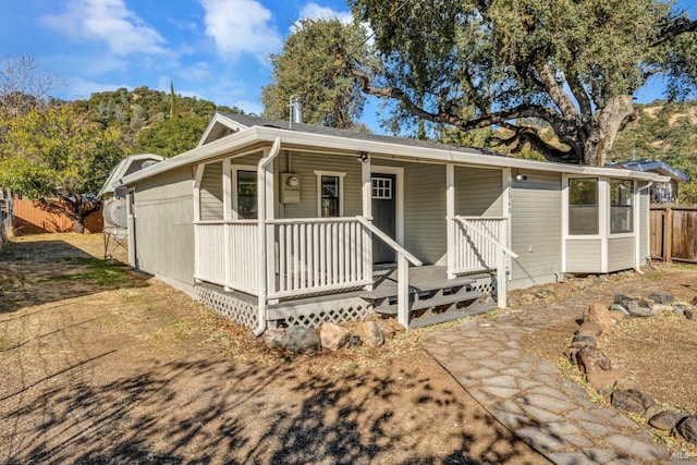 view of front of home featuring fence and covered porch