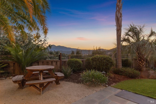220 Deer Park Ave, San Rafael, CA 94901 - yard at dusk featuring a mountain view, a fenced backyard, and a patio