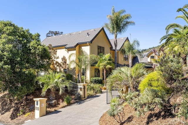 220 Deer Park Ave, San Rafael, CA 94901 - view of front of house with stucco siding, a gate, a fenced front yard, and a tile roof