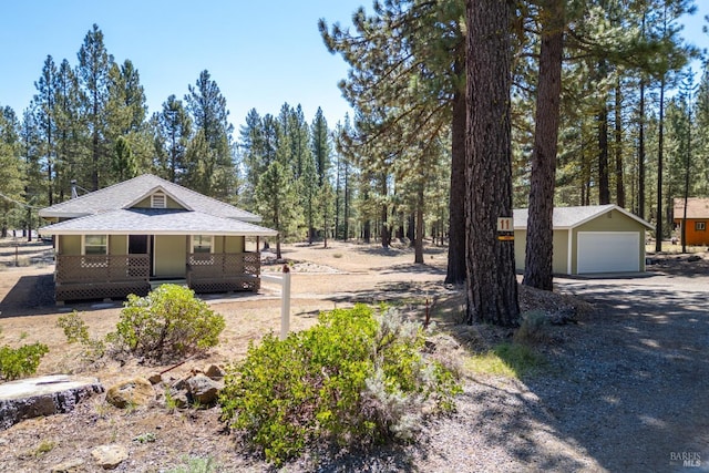 12321 Big Springs Blvd, Old Station, CA 96071 - view of front of house featuring covered porch, an outdoor structure, a garage, roof with shingles, and driveway
