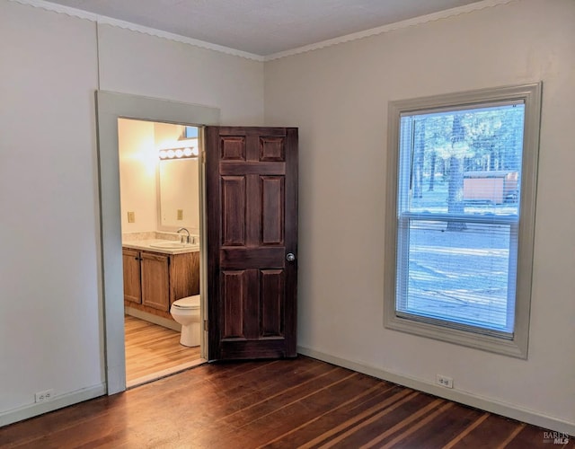 12321 Big Springs Blvd, Old Station, CA 96071 - empty room featuring dark wood-style flooring, crown molding, a sink, and baseboards