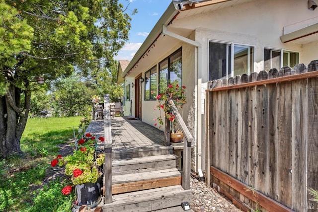 view of property exterior featuring stucco siding and a wooden deck