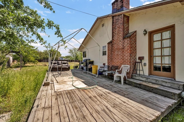 wooden deck featuring a lawn, fence, and outdoor lounge area