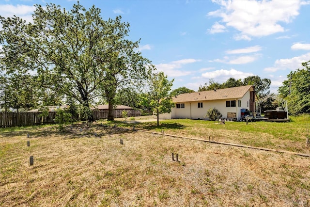view of yard featuring fence and a detached carport