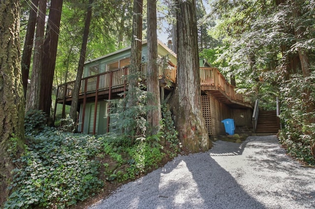 view of side of property featuring a deck and stairway