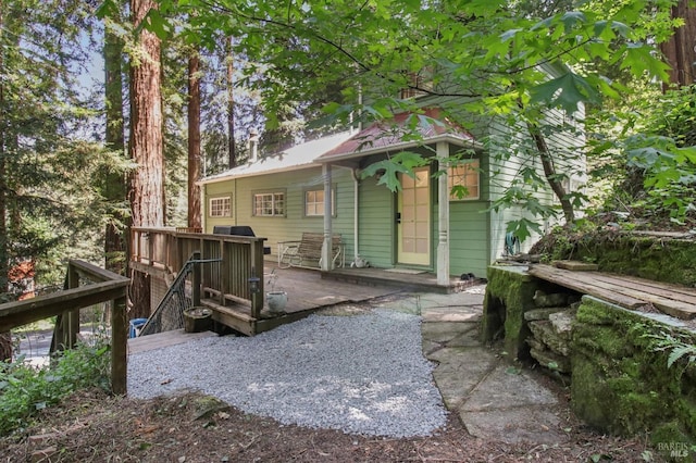 rear view of house with a wooden deck