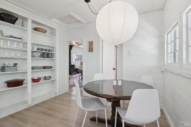 dining area with built in shelves and light wood-type flooring