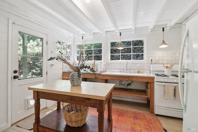 sunroom with a sink and beam ceiling