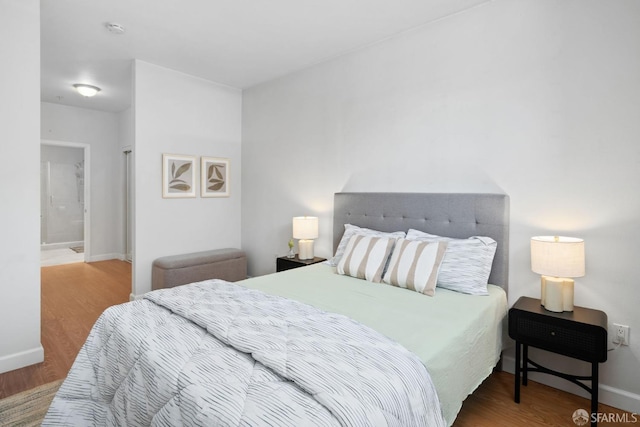 bedroom featuring baseboards and wood finished floors