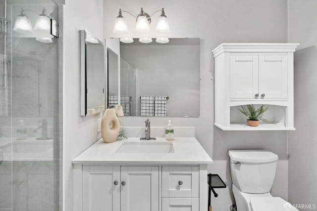 full bath with vanity, toilet, and a shower stall