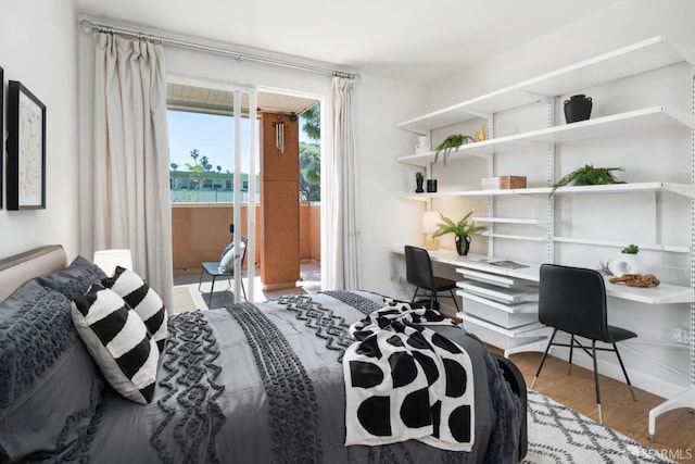 bedroom featuring access to exterior and wood finished floors