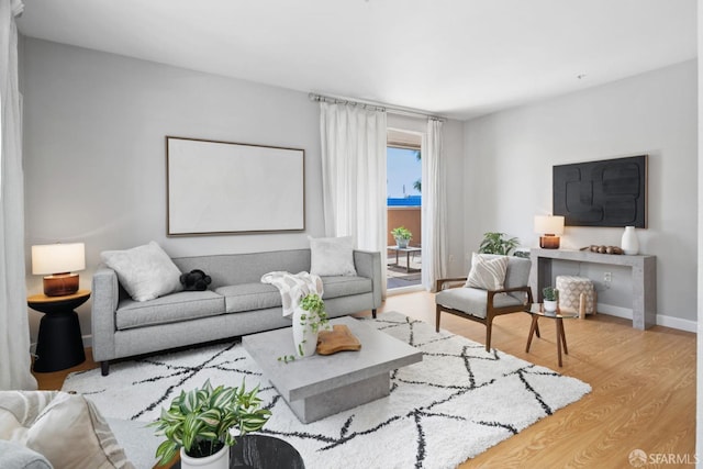 living room featuring baseboards and wood finished floors