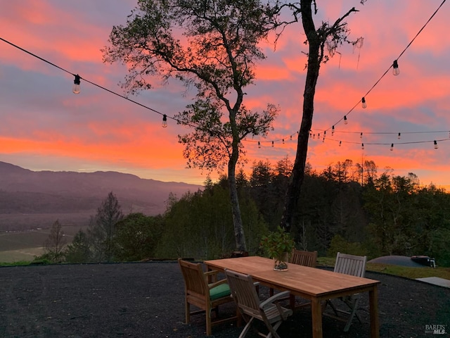 22855 Chianti Rd, Geyserville, CA 95441 - patio terrace at dusk featuring outdoor dining area and a mountain view