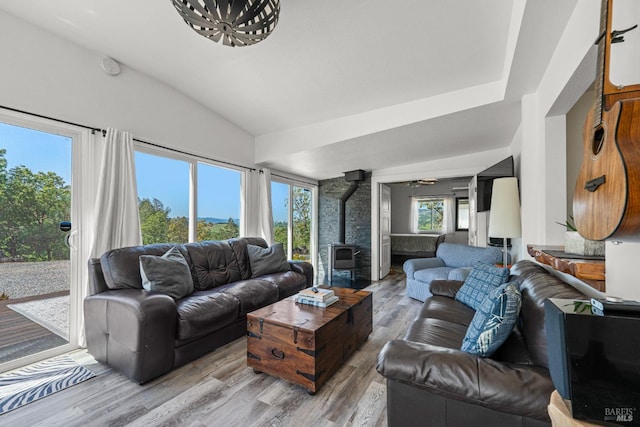 22855 Chianti Rd, Geyserville, CA 95441 - living room featuring a wood stove, vaulted ceiling, and light wood-style flooring