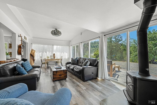 22855 Chianti Rd, Geyserville, CA 95441 - sunroom with healthy amount of natural light, vaulted ceiling, and a wood stove