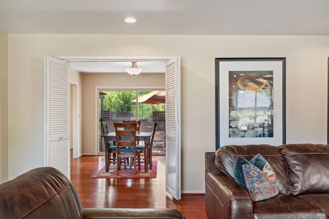 living room featuring recessed lighting, baseboards, and wood finished floors