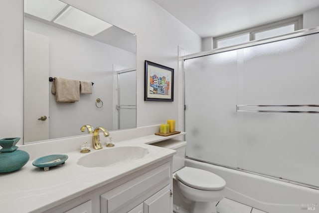 bathroom with vanity, enclosed tub / shower combo, and toilet