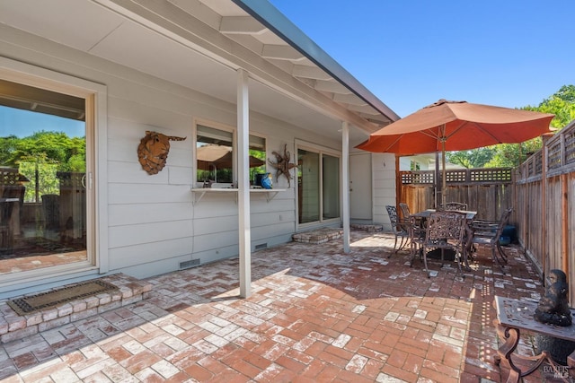 view of patio featuring outdoor dining area and a fenced backyard