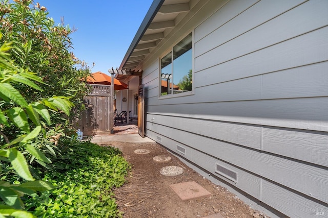 view of home's exterior featuring fence and crawl space