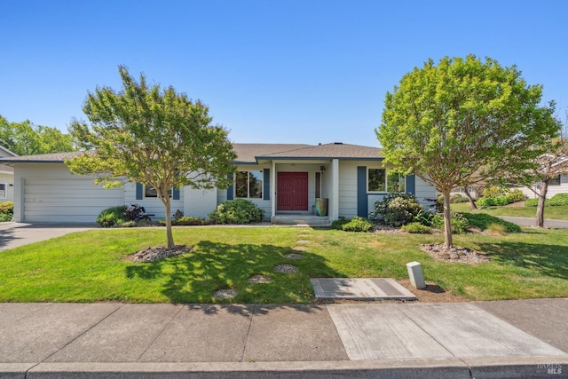 ranch-style house with concrete driveway, a front yard, and a garage